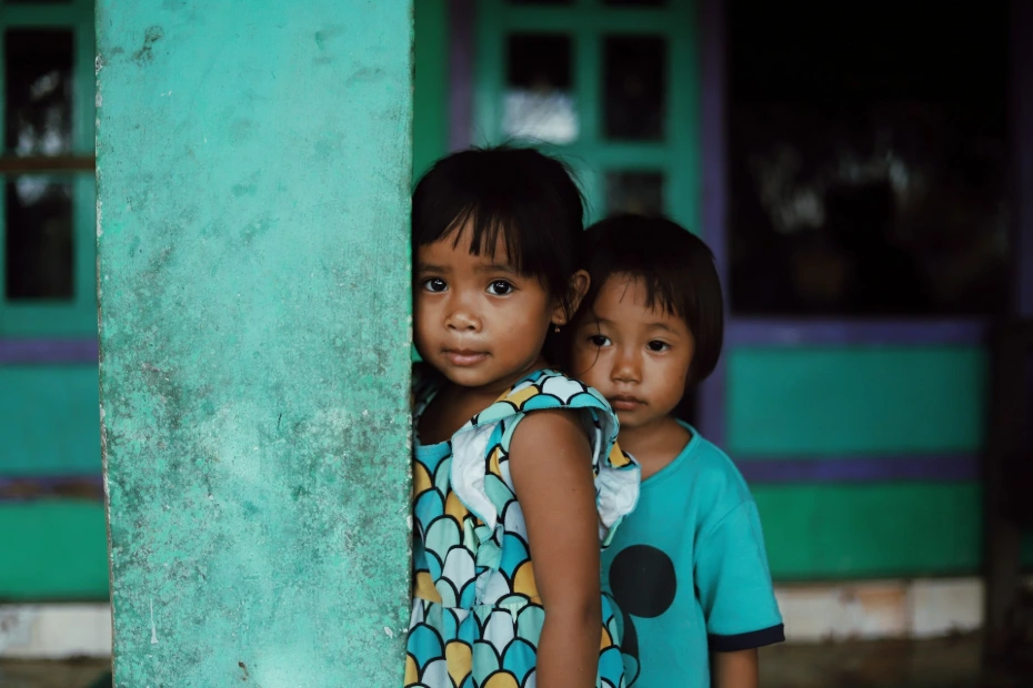 Two young children standing next to each other
